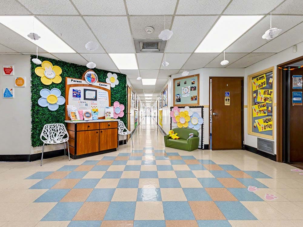 Hallway decorated with a "Parent Center" sign, flower cutouts, and a green couch