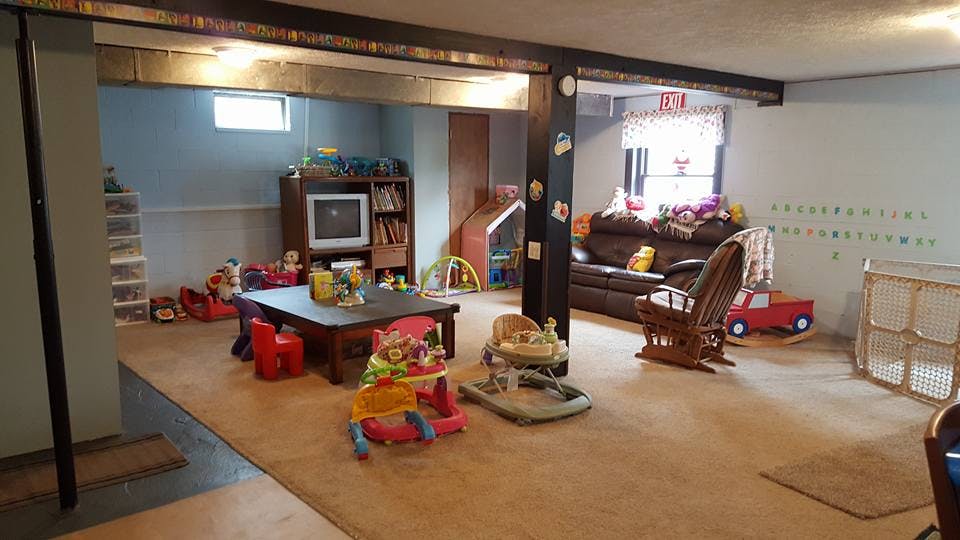 Basement room with various children's toys and furniture