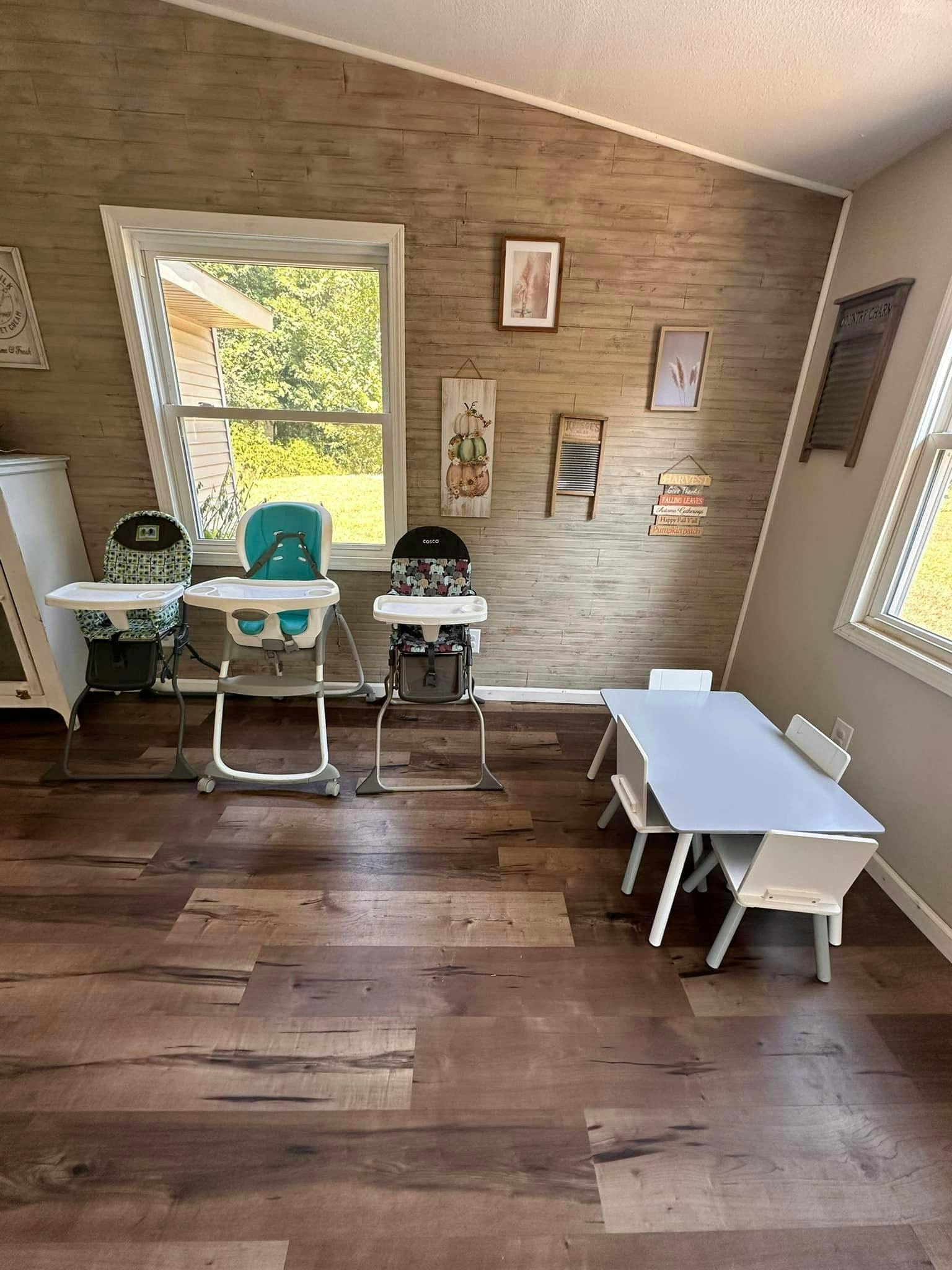 Three high chairs and a child-sized table with chairs