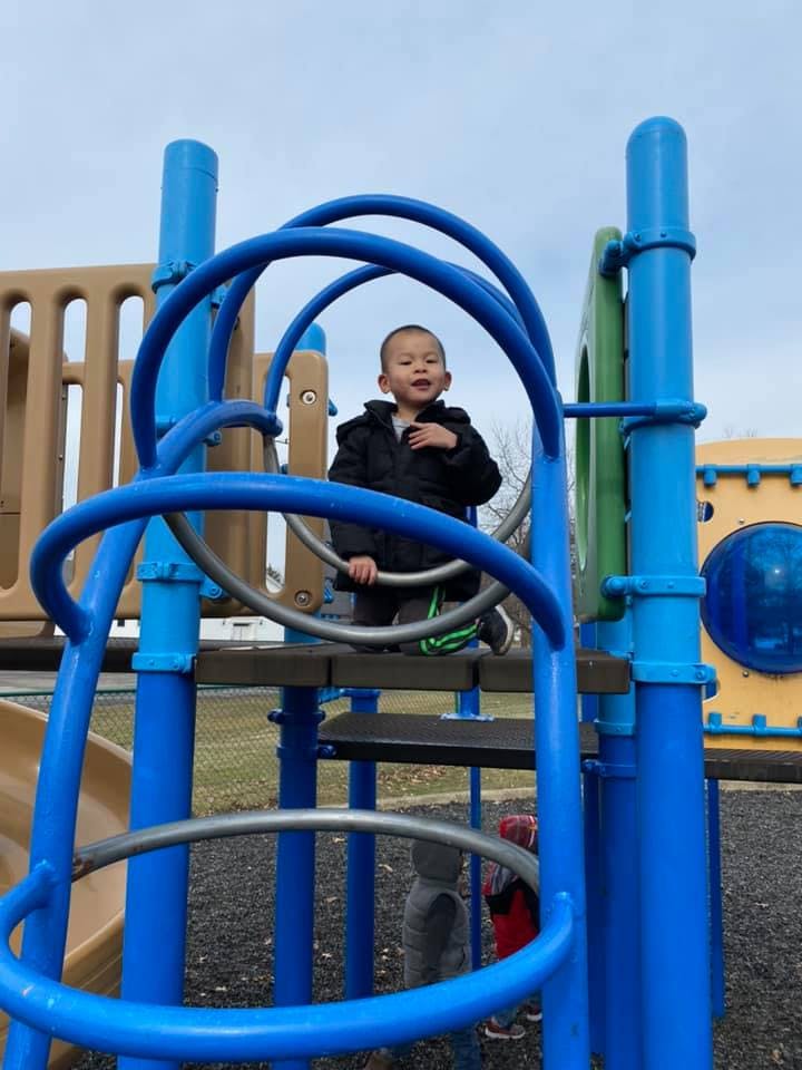 Child on playground climbing structure