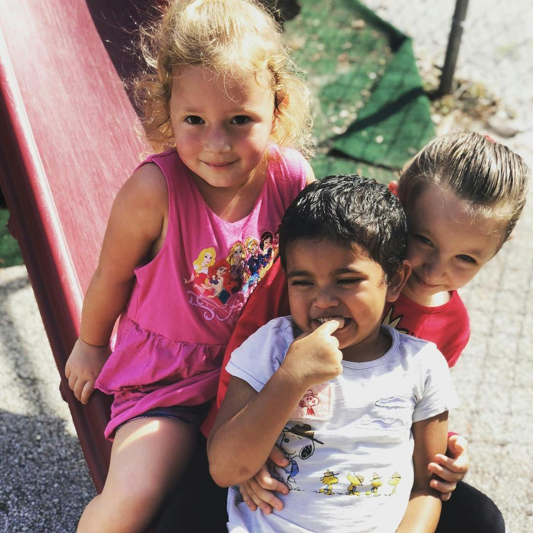 Three children on a slide