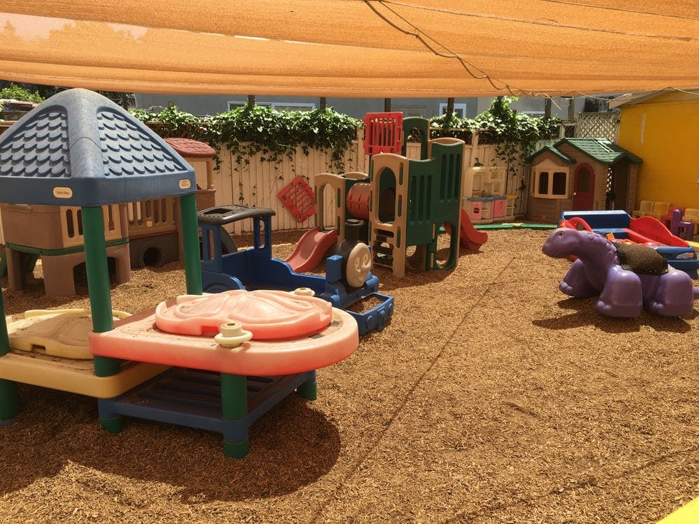 Outdoor playground with various play structures and sand