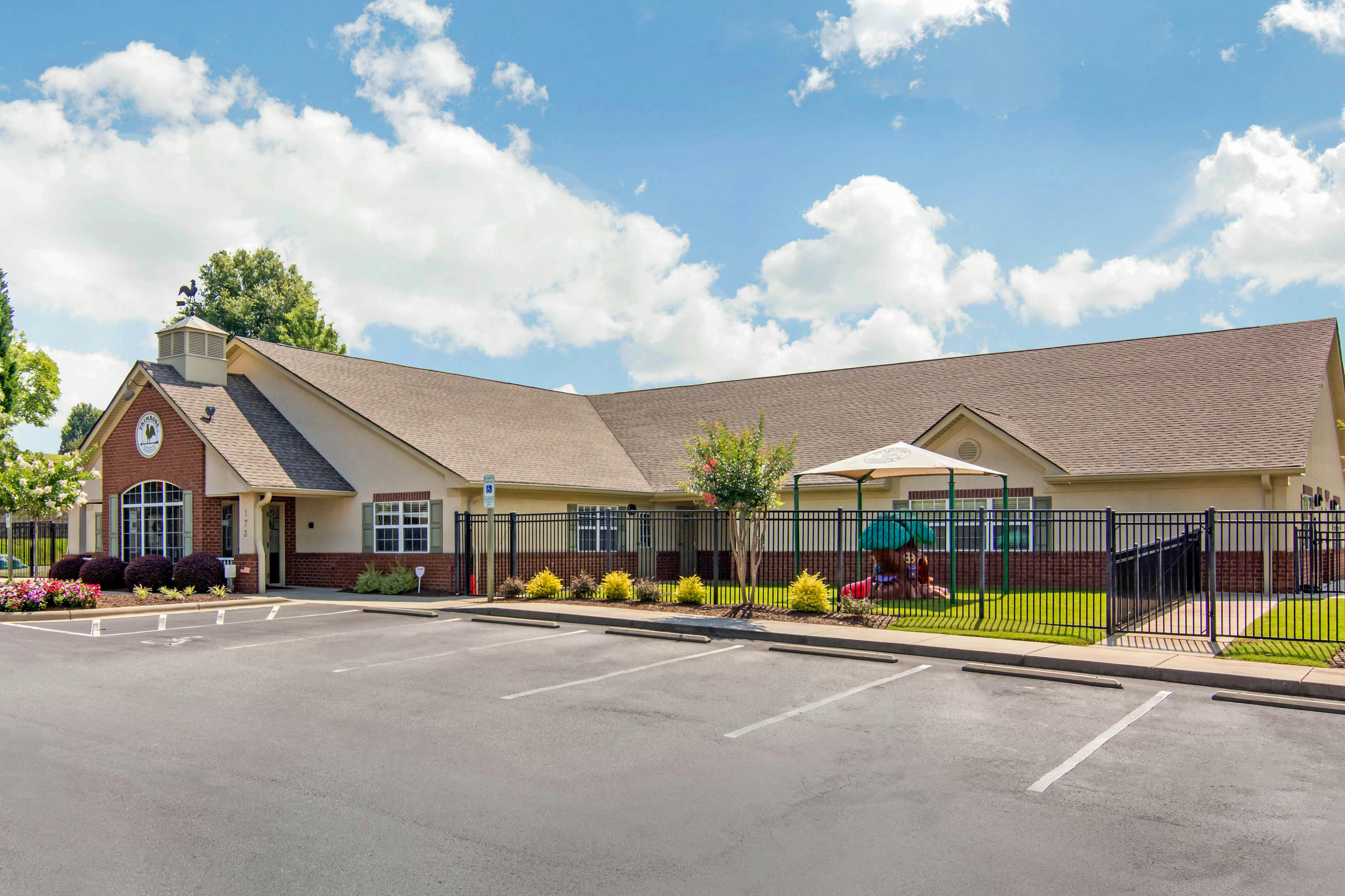 Exterior view of a commercial building with a small playground area