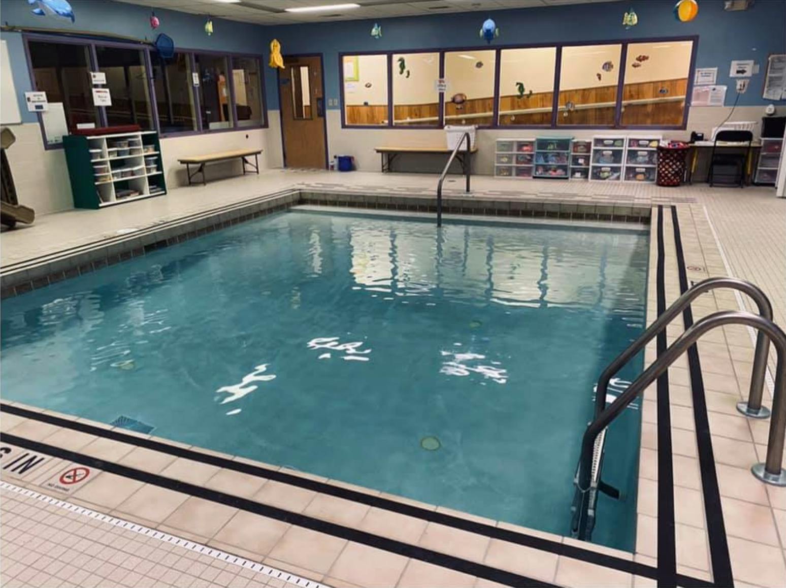 Indoor swimming pool with steps and handrails