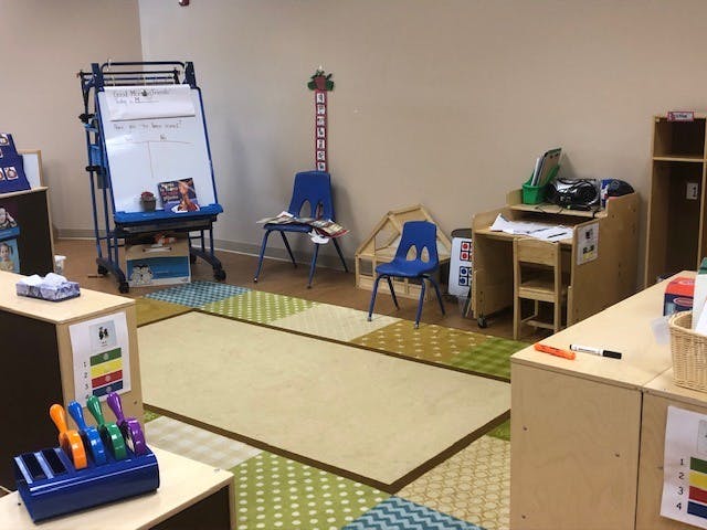 Classroom with whiteboard, small chairs, and desks