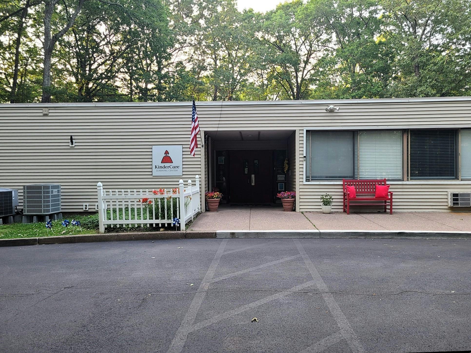 KinderCare Learning Centers sign on a building with an American flag