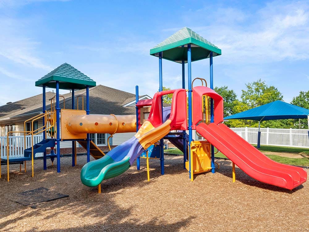 Colorful playground with slides, tunnels, and climbing structures