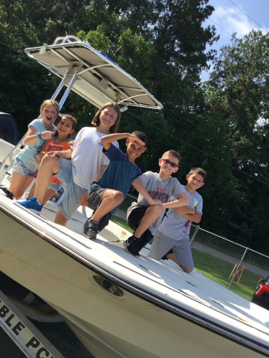 Group of children and teens posing on a boat