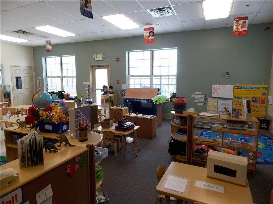 Classroom with small tables, chairs, and learning materials