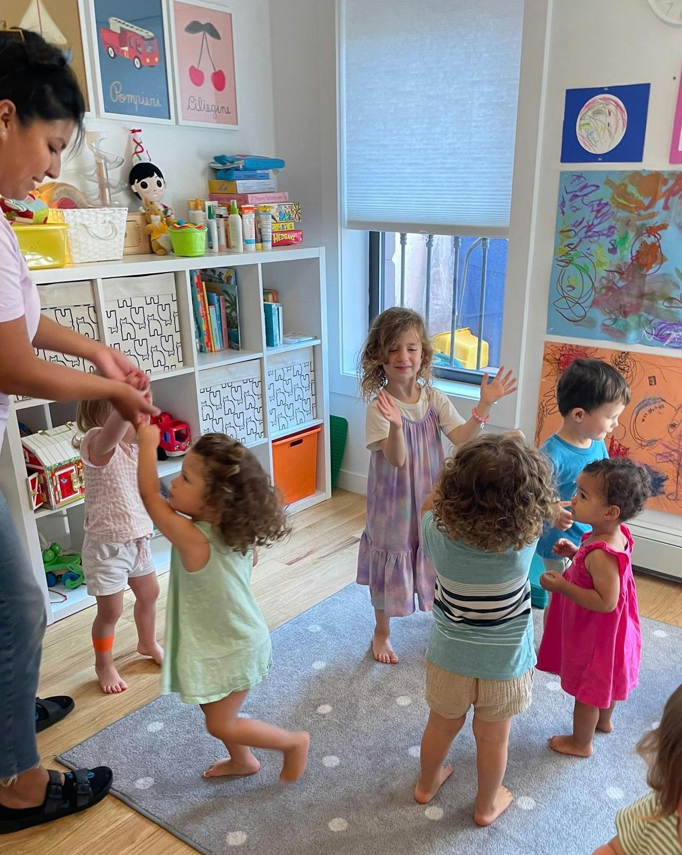 Person interacting with children in a classroom