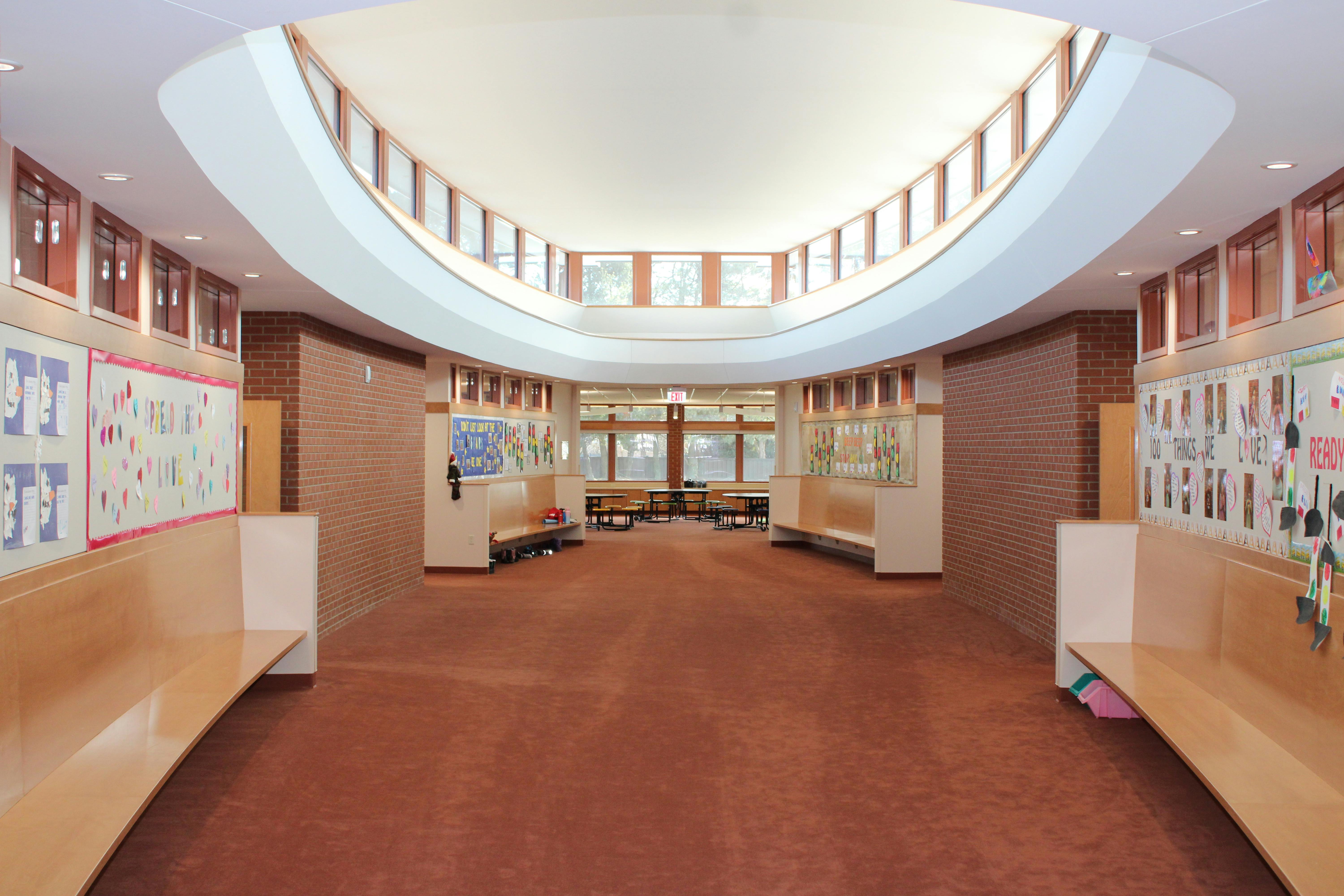 Curved hallway with benches and display boards