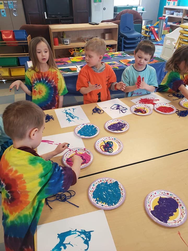 Children painting at a table