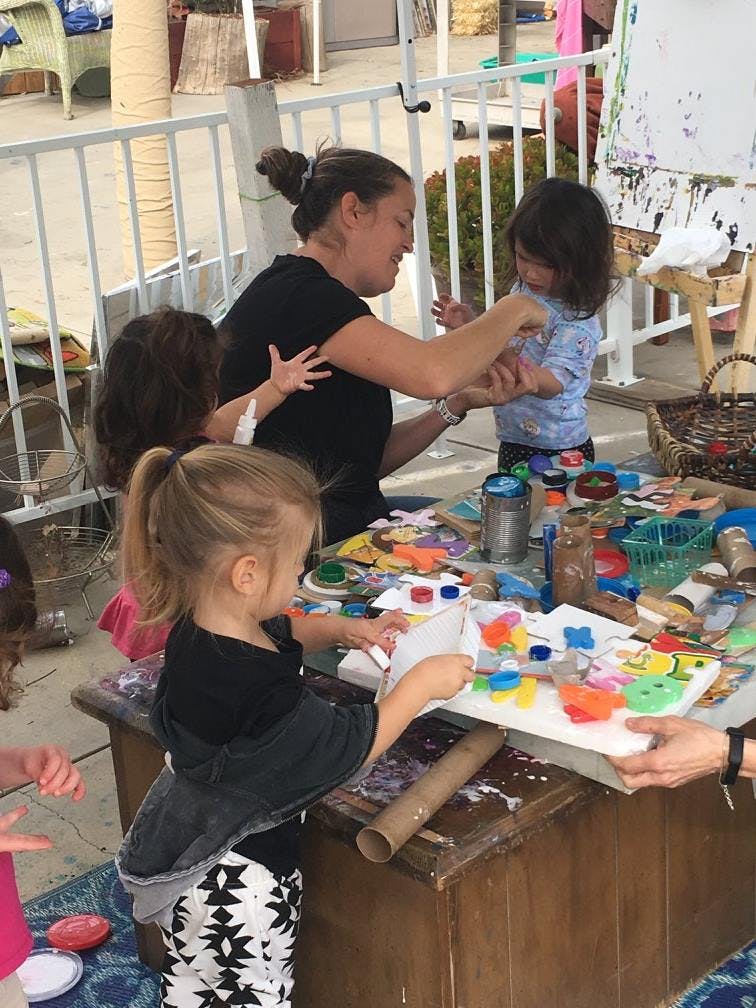 Adult and children doing crafts at a table