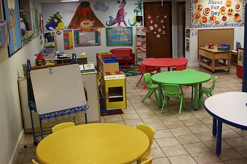 Preschool classroom with small tables and chairs