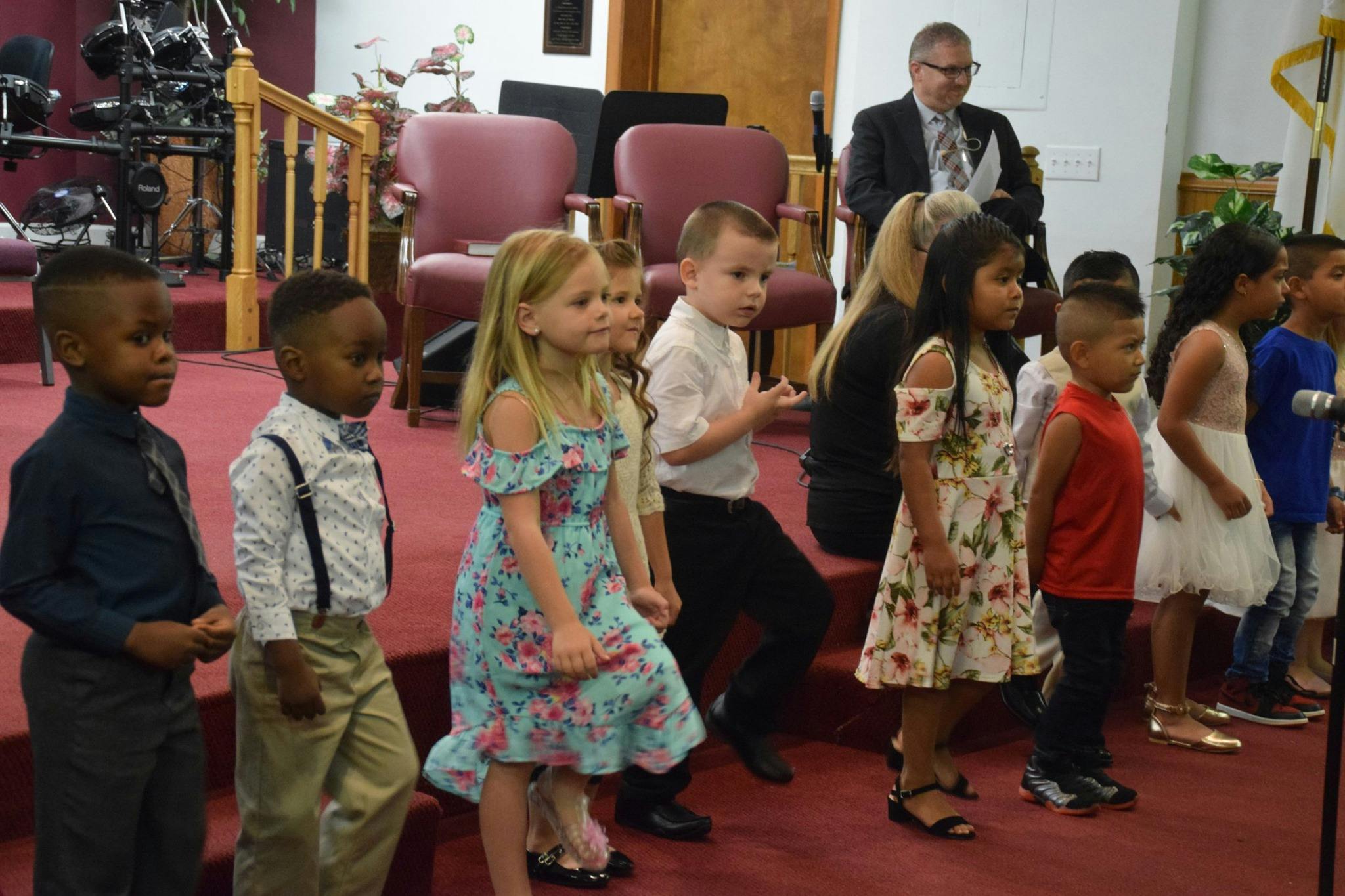 Group of children standing on a stage