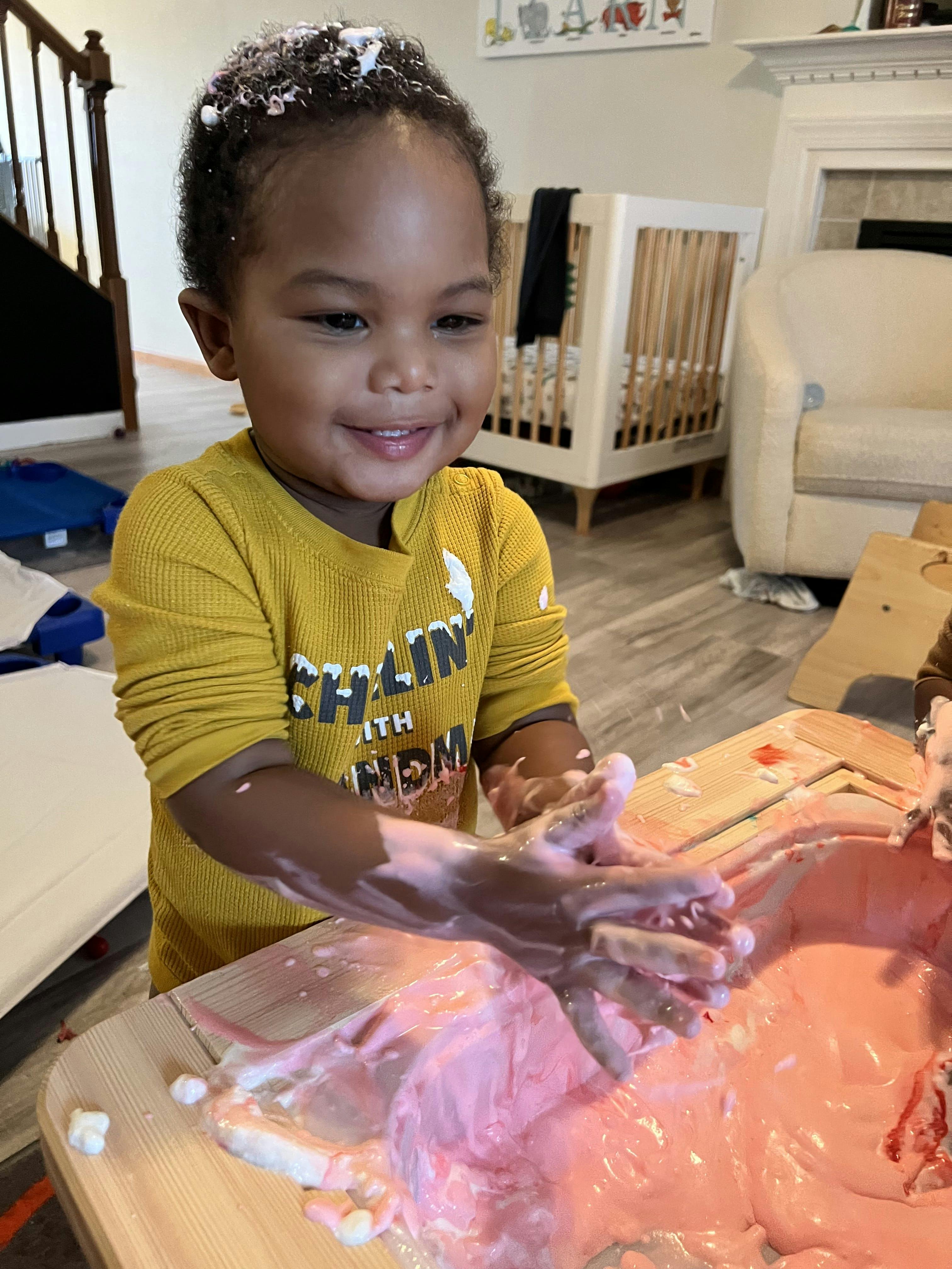 Child playing with pink slime