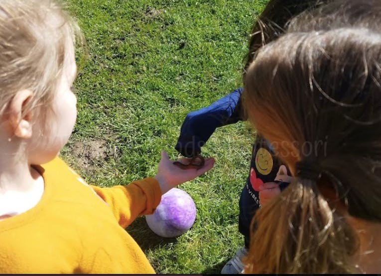 Child holding out hand to another child