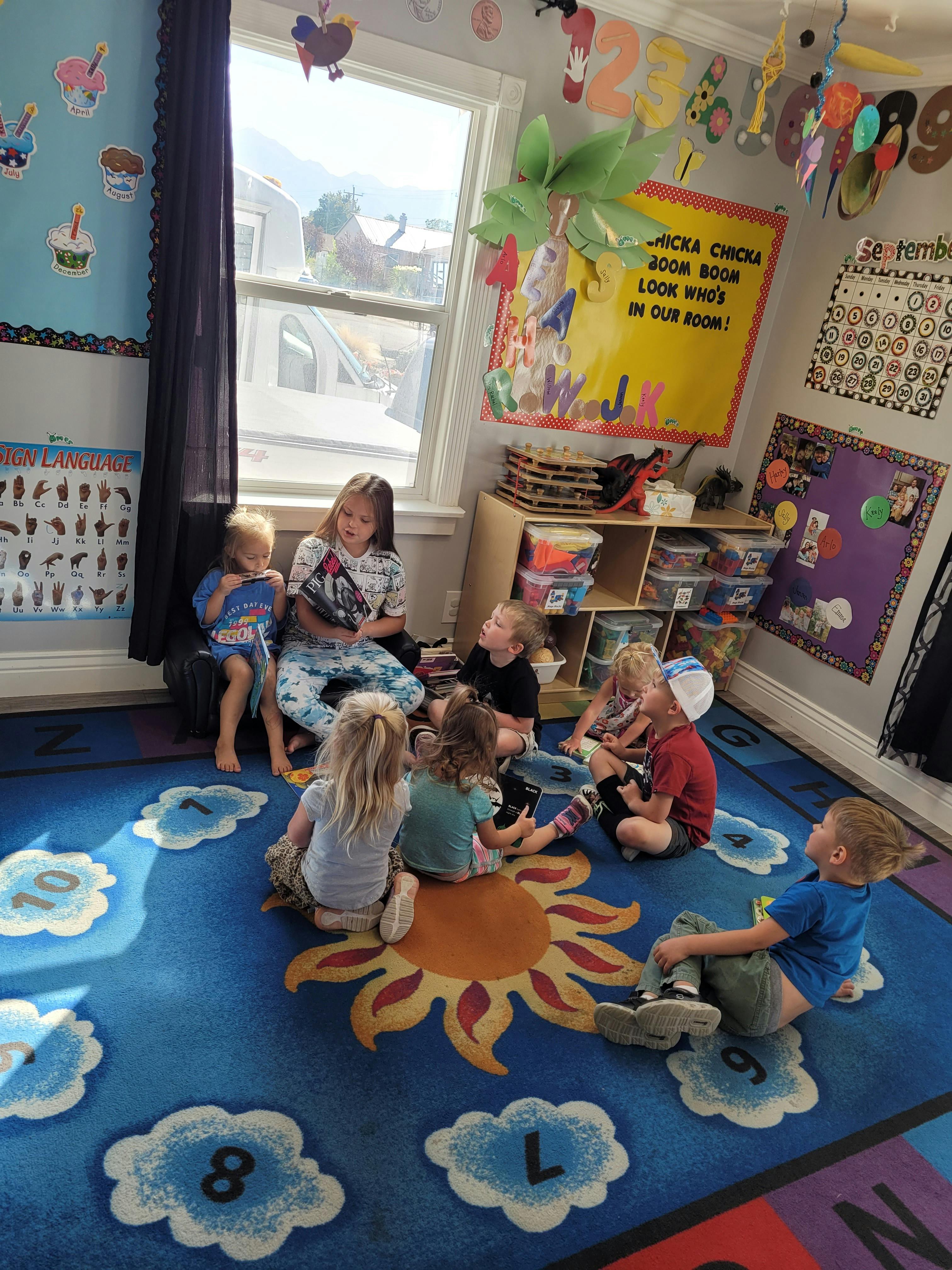 Children sitting on a rug in a classroom