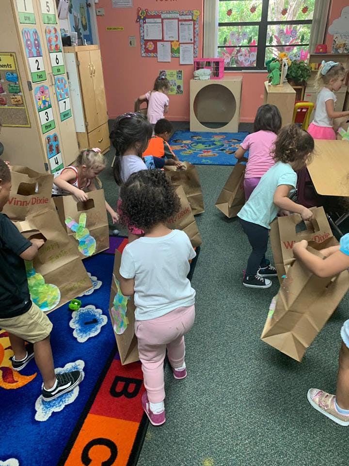 Children in a classroom playing with paper bags