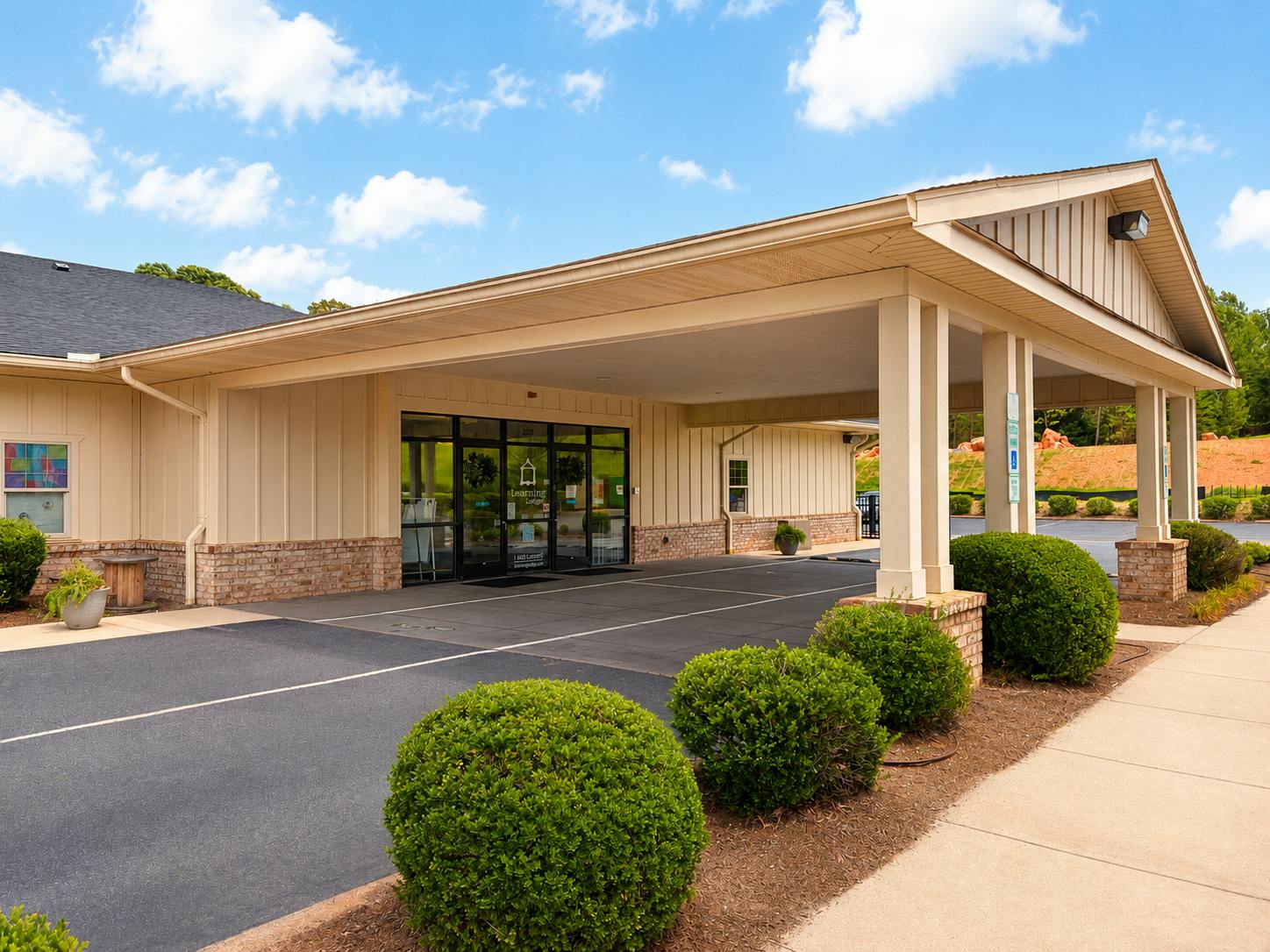 Exterior of a commercial building with a covered drive-through entrance
