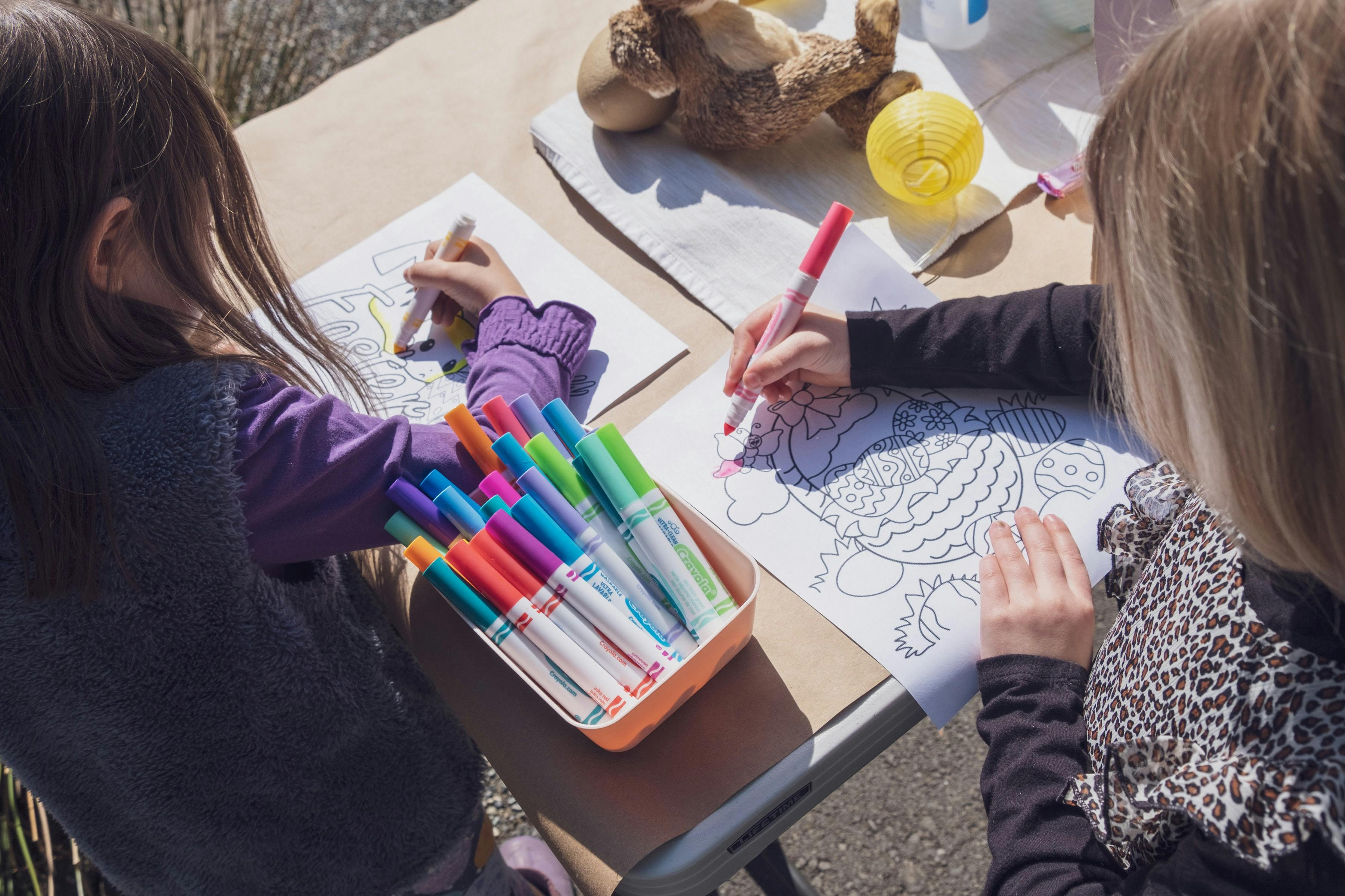 Two children coloring with markers