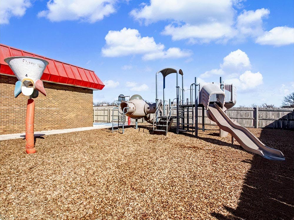 Outdoor playground with slide and small rocket