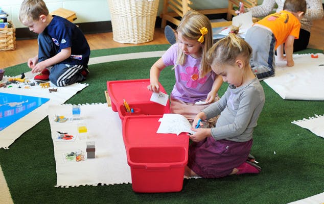 Children playing on the floor in a classroom