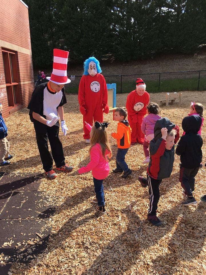 People in costumes with children on wood chips