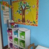 Classroom with a tree drawing on the wall and storage shelves