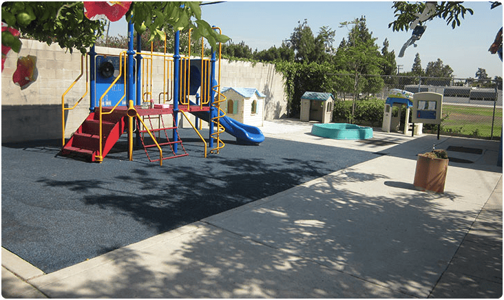 Empty playground with colorful climbing structure and small playhouses