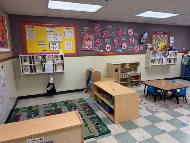 Children's classroom with bulletin boards, small tables, and play furniture