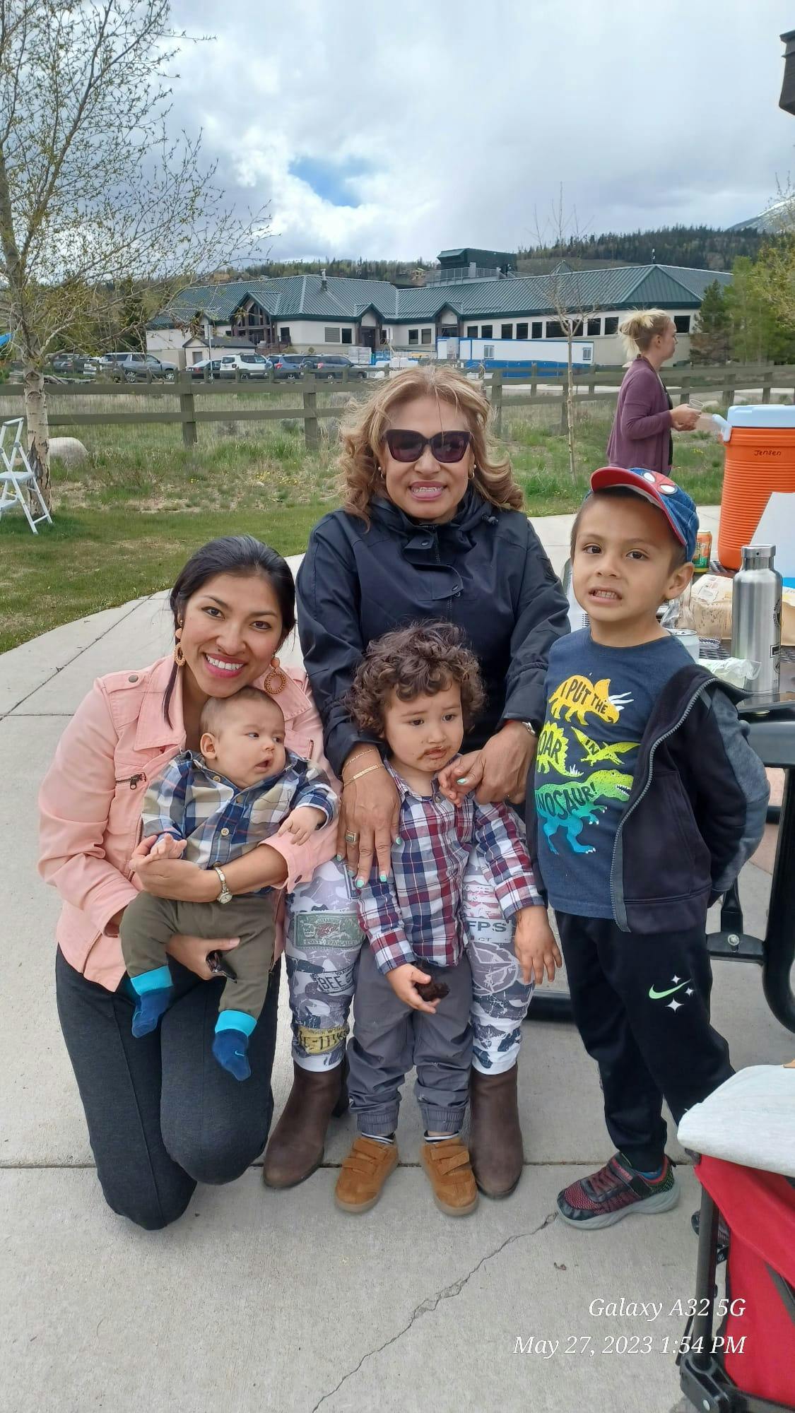 Three adults and three children posing outdoors