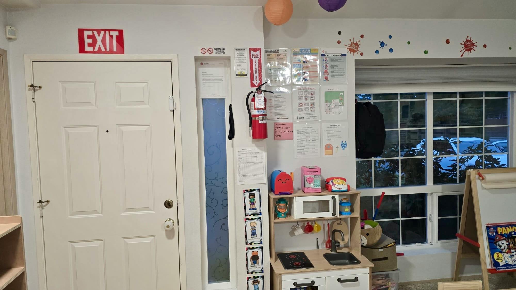 Childcare facility wall with fire safety equipment and posters