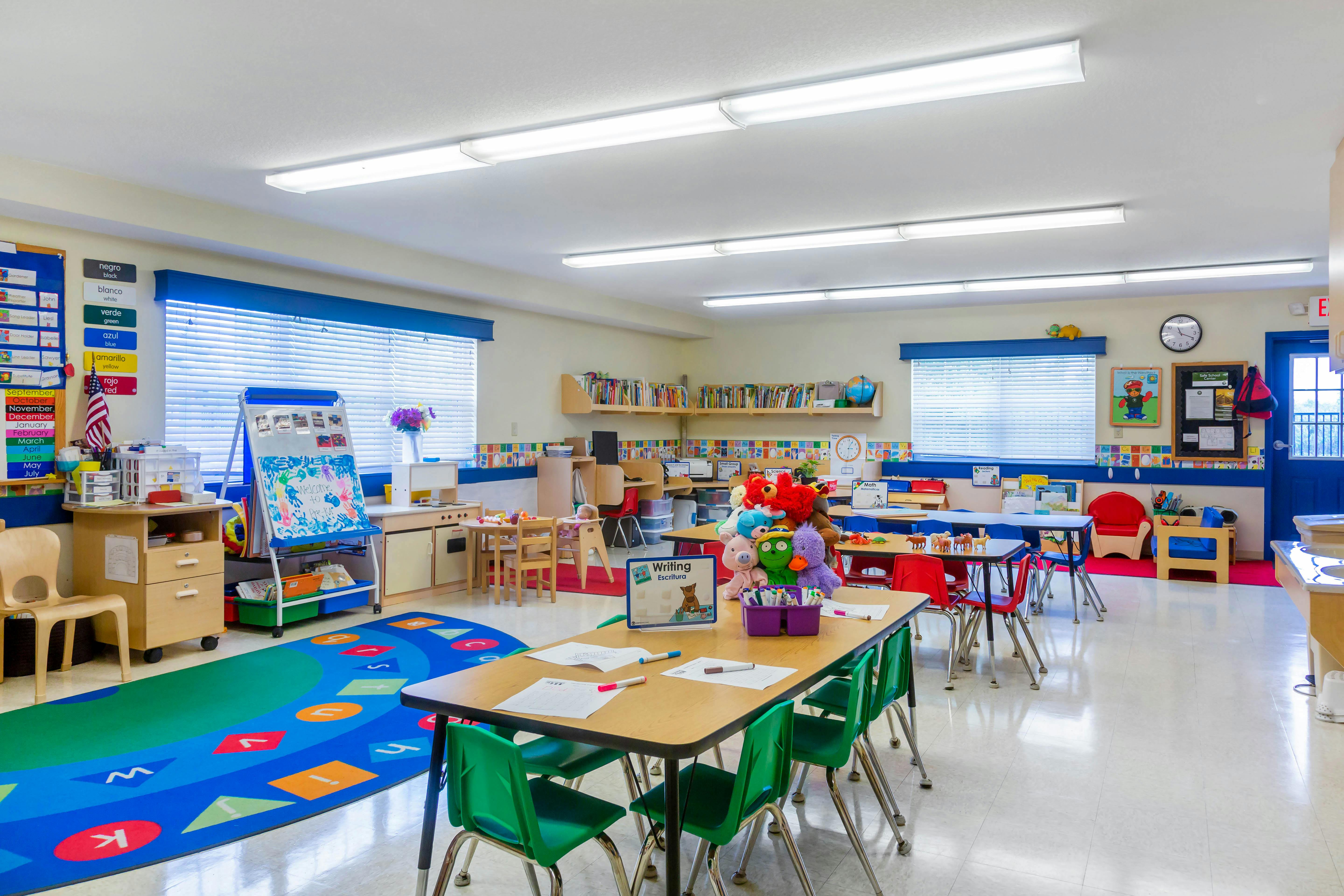 Colorful and organized preschool classroom with small tables and chairs