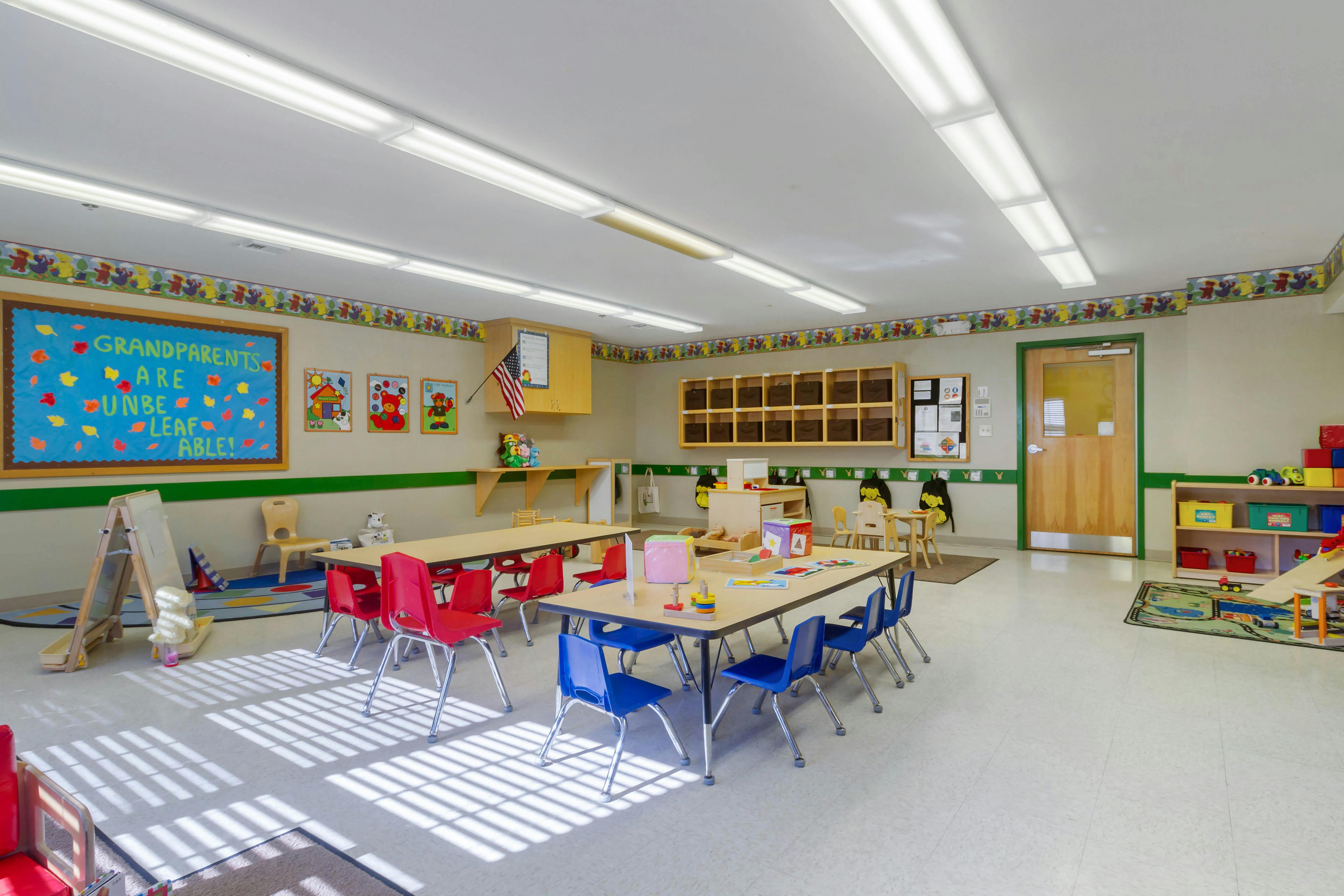 Classroom with child-sized tables, chairs, and learning materials