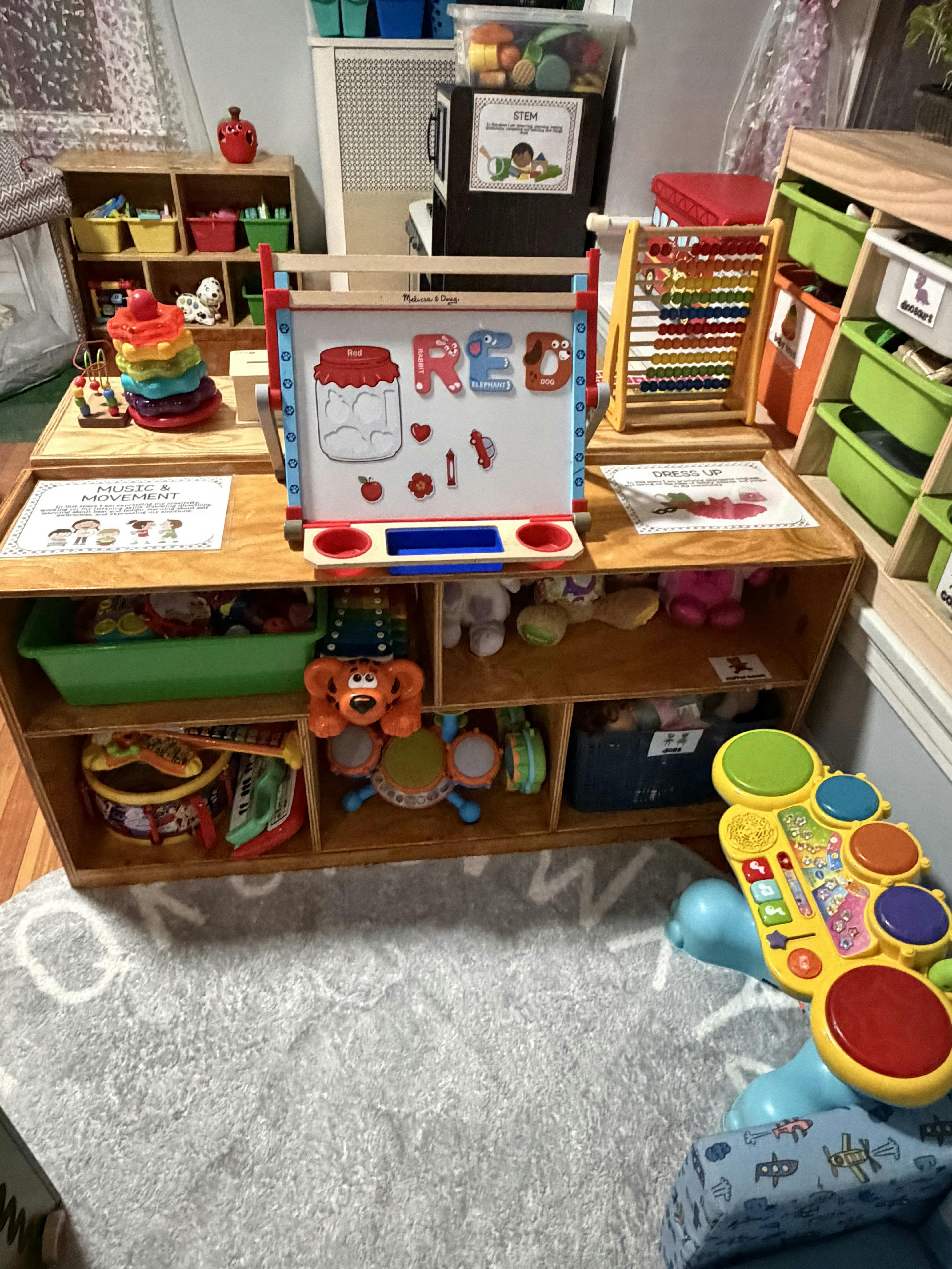 A wooden shelf with a variety of colorful children's toys and learning aids