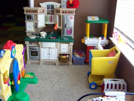 Children's play kitchen and other toys in a room