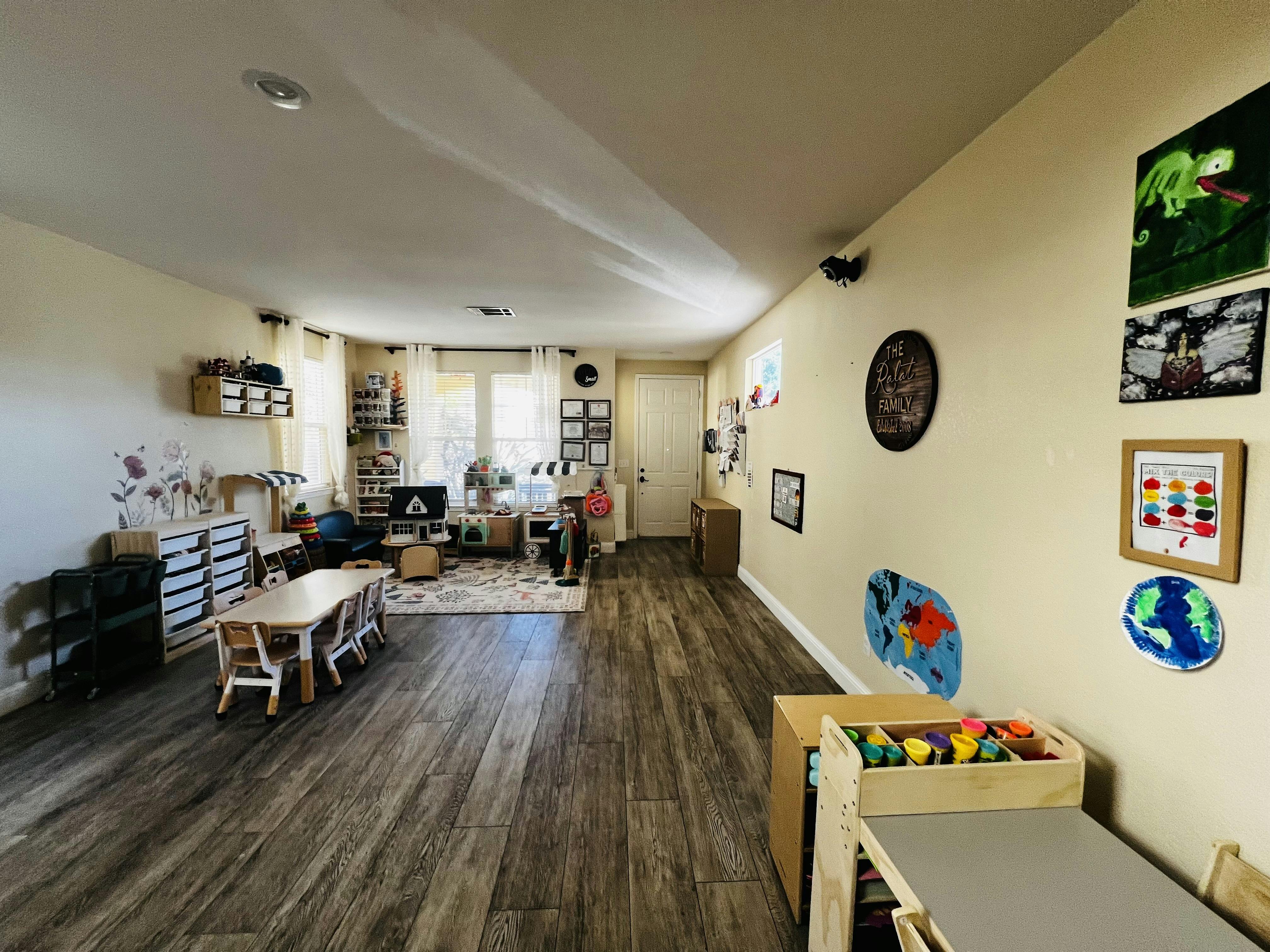 Child-sized tables and play kitchen in a playroom