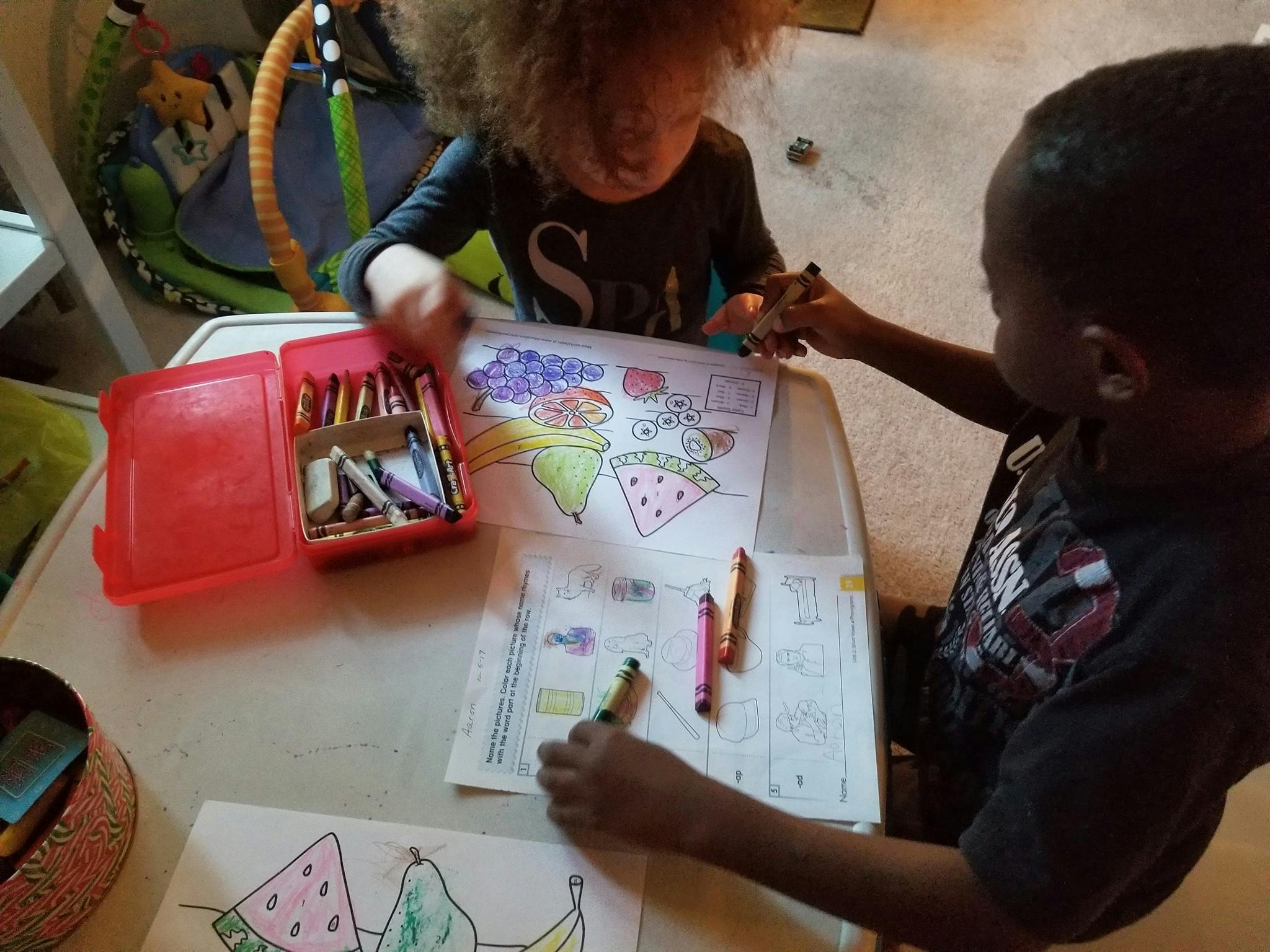 Two children coloring at a table