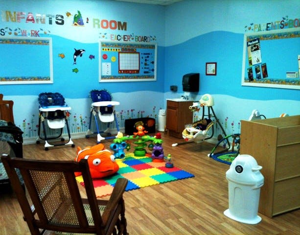Infants' room with high chairs, play mat, and baby swing