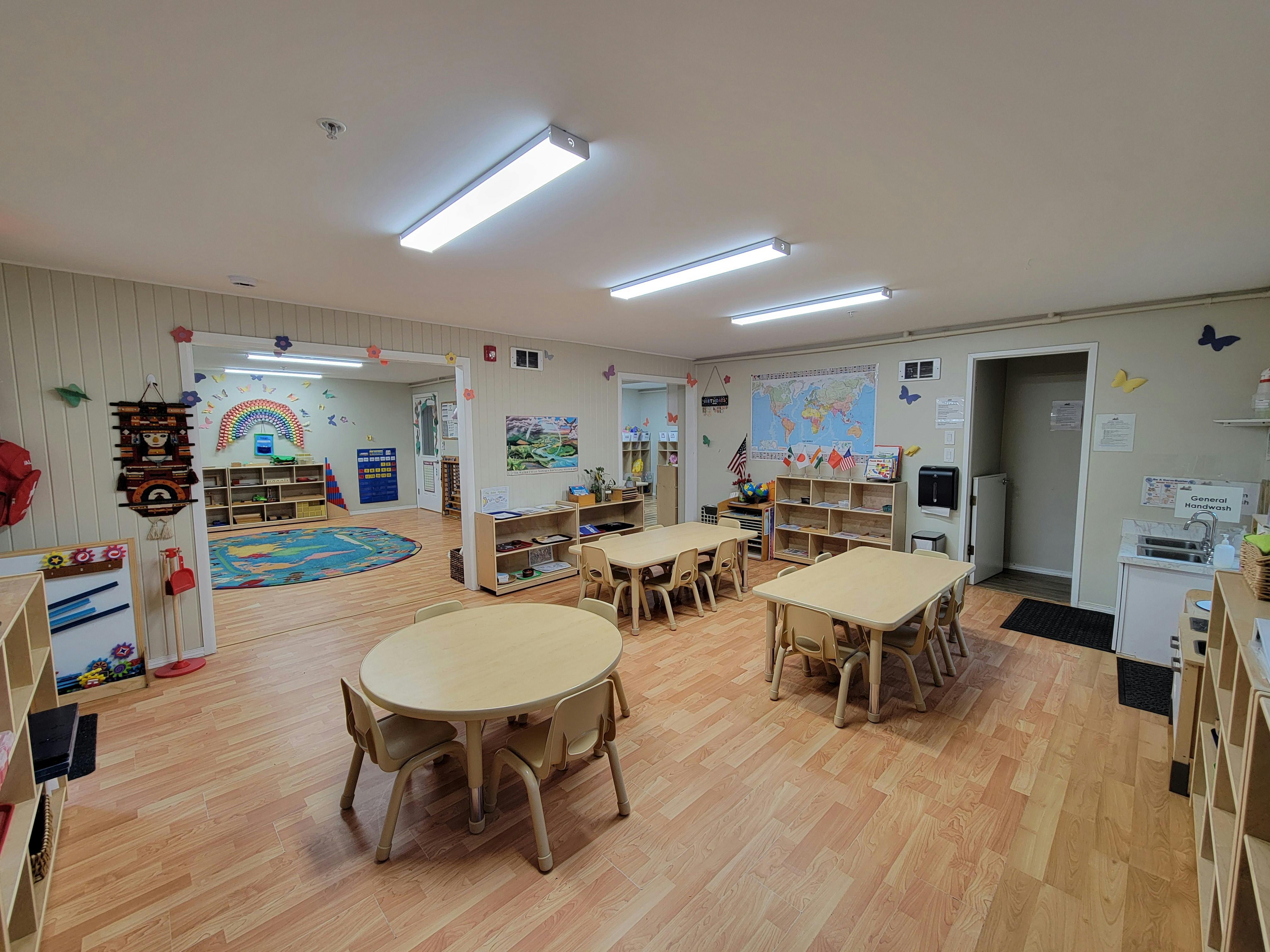Empty classroom with small tables and chairs