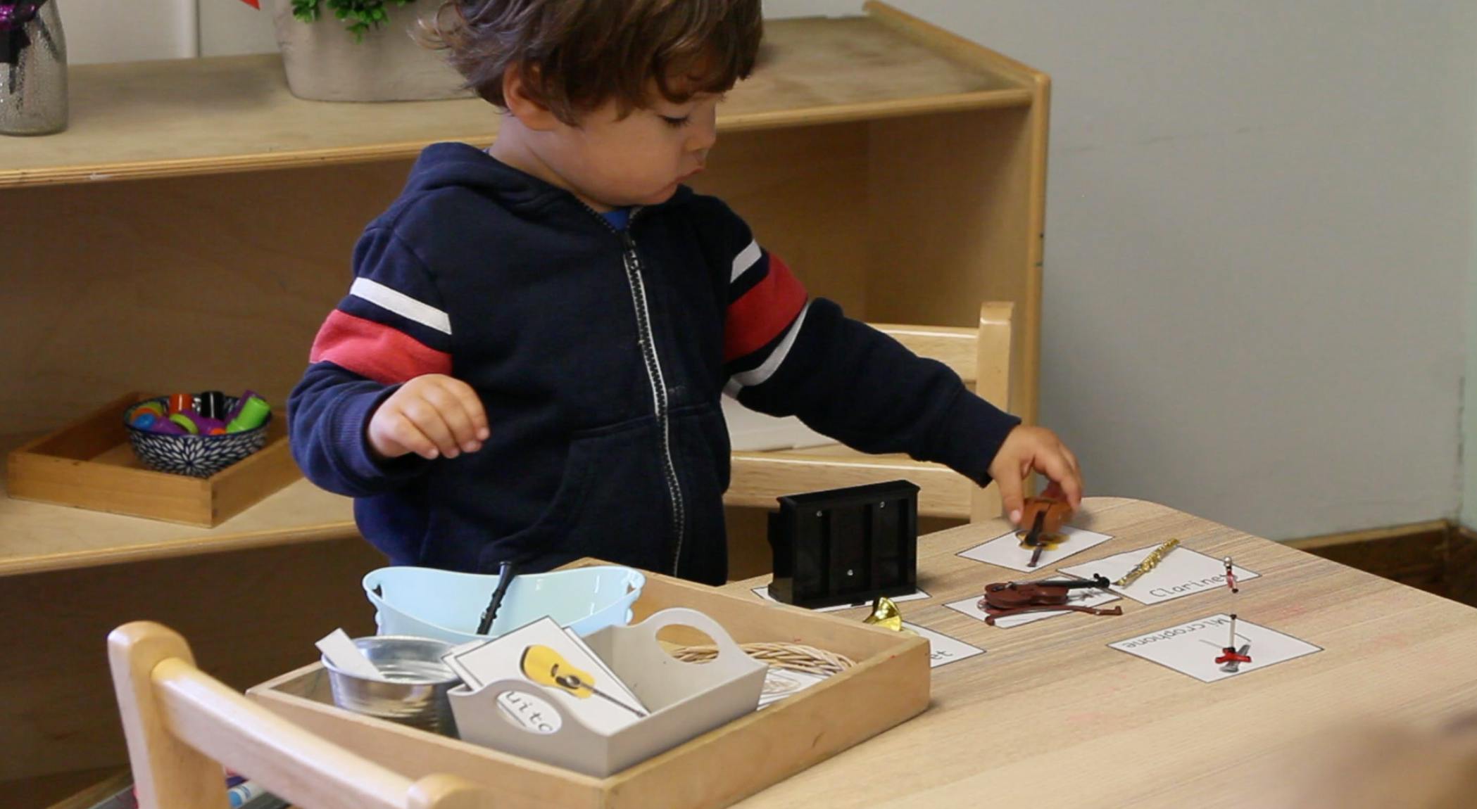Child playing with items on a table