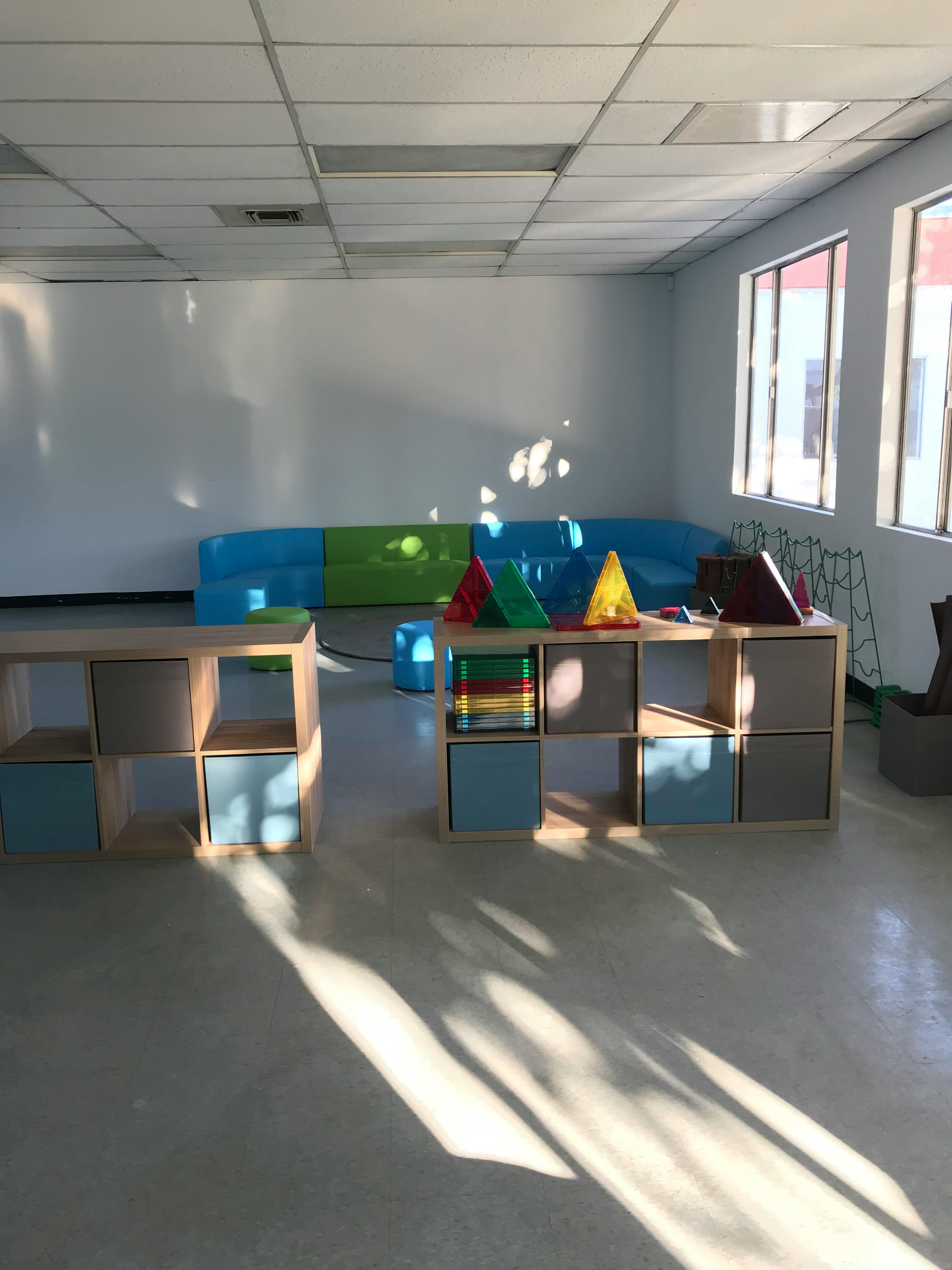 Empty classroom with modular furniture and sunlight streaming sunlight