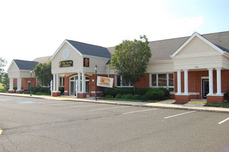 Building with a parking lot in front