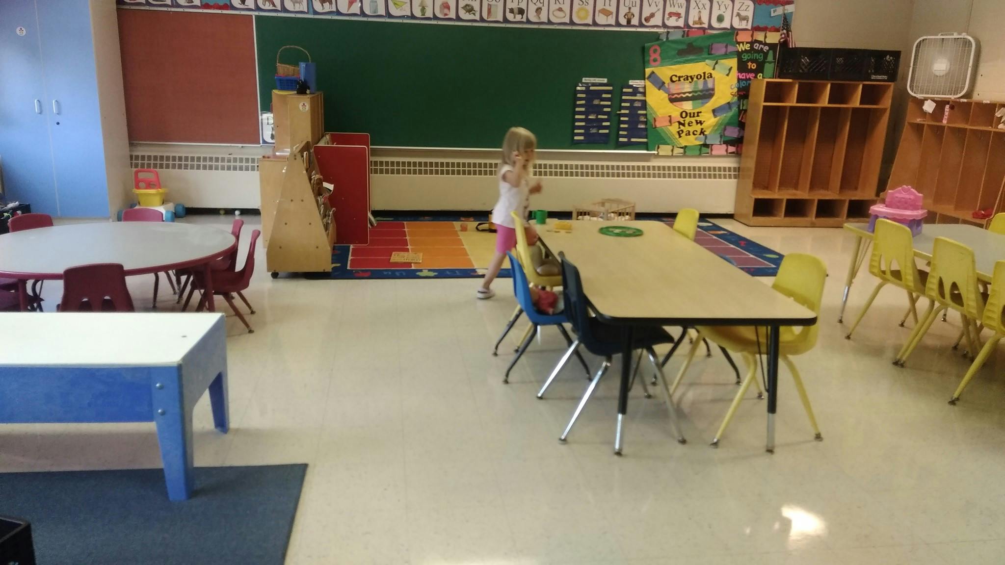 Child walking in a classroom