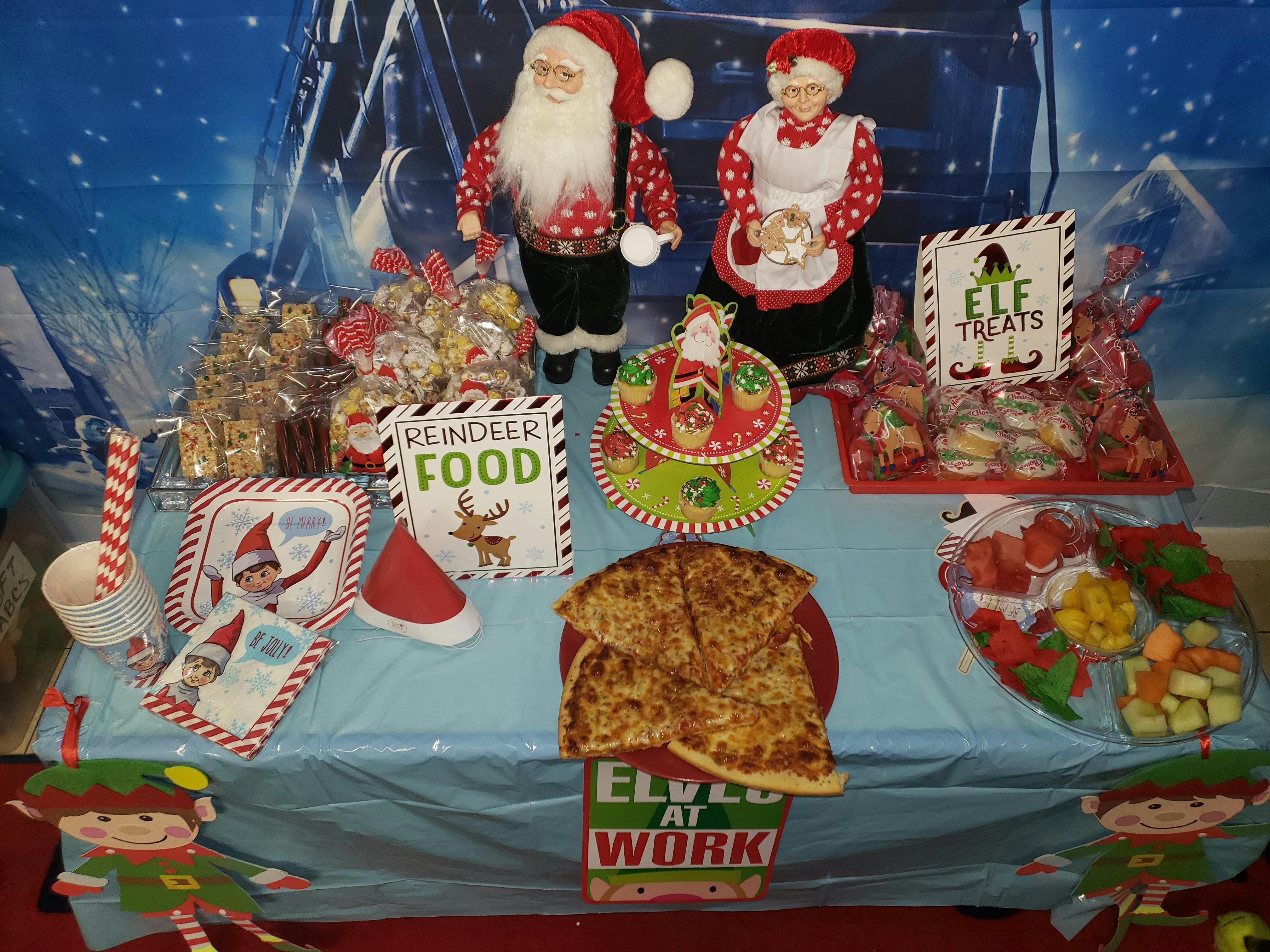Table with Christmas decorations, food, and treats