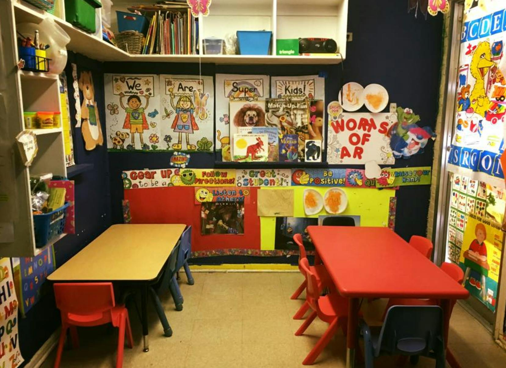 Classroom with small tables and chairs, decorated walls