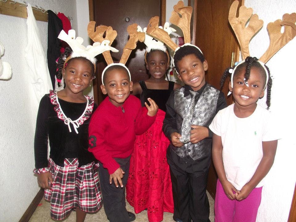 Five children wearing reindeer antlers