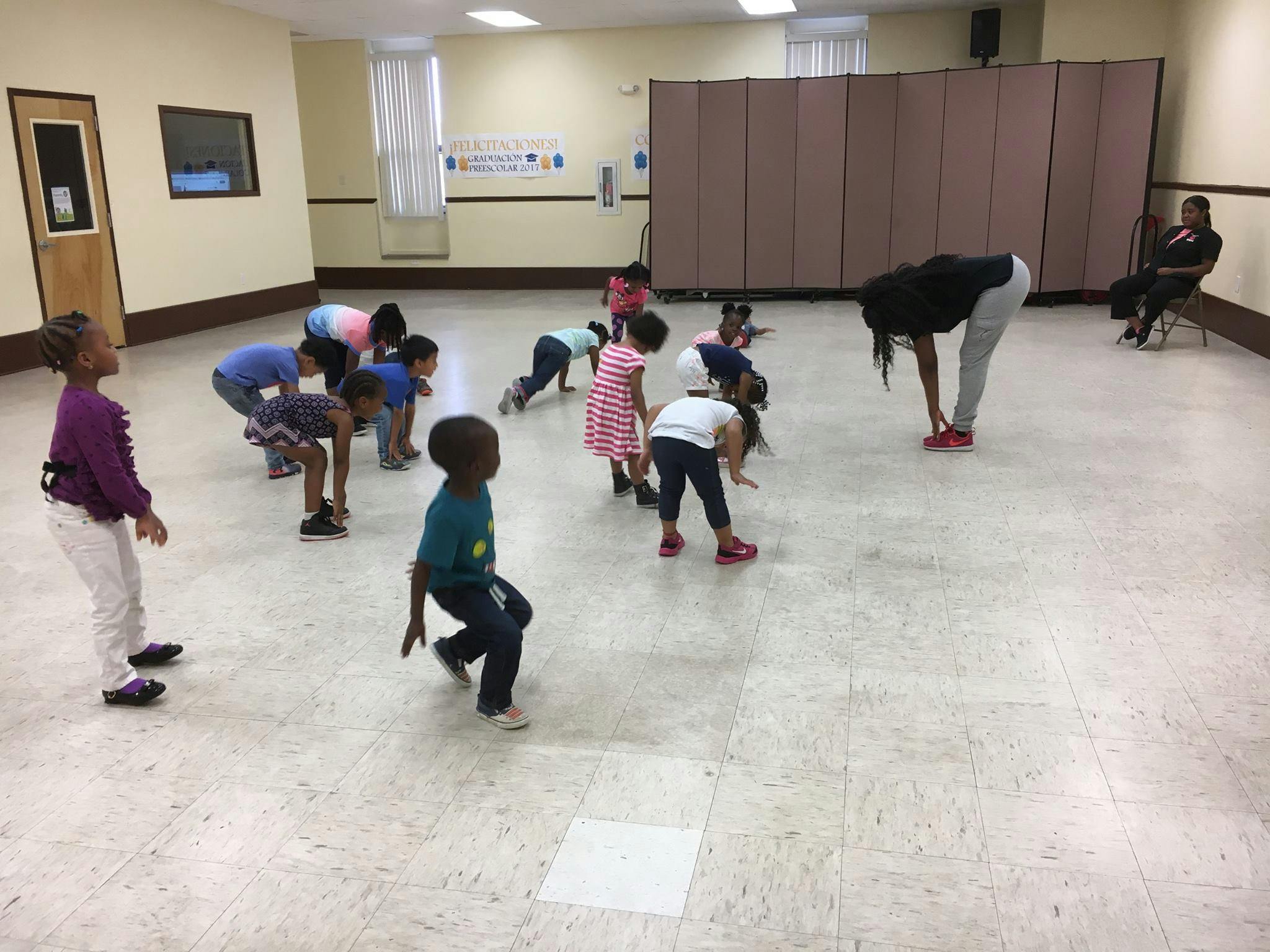 Adult and children exercising in a room