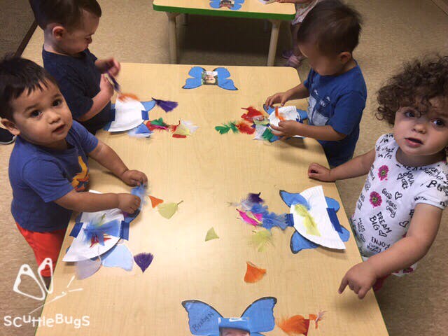 Children at a table doing crafts with crafts